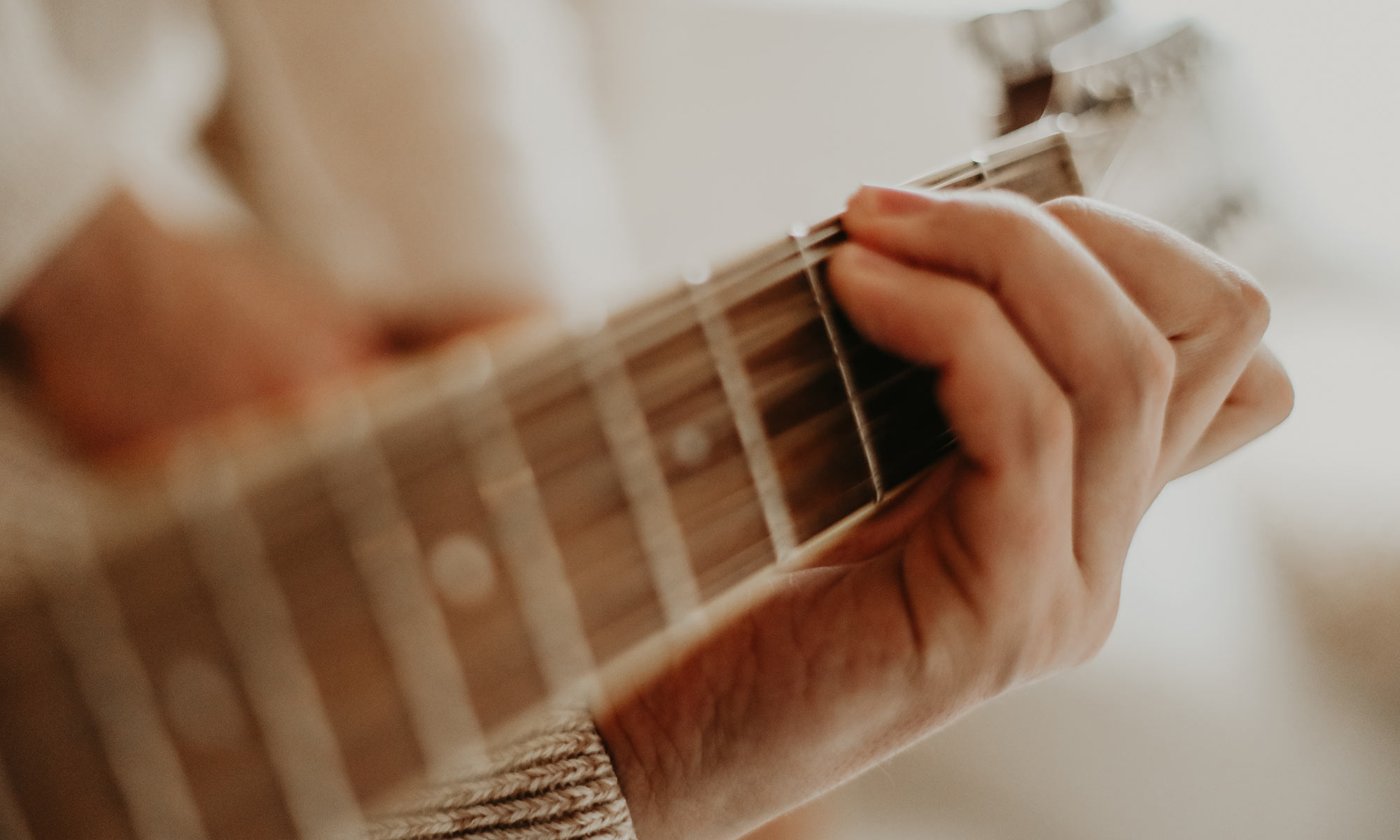 Close up of person playing a guitar
